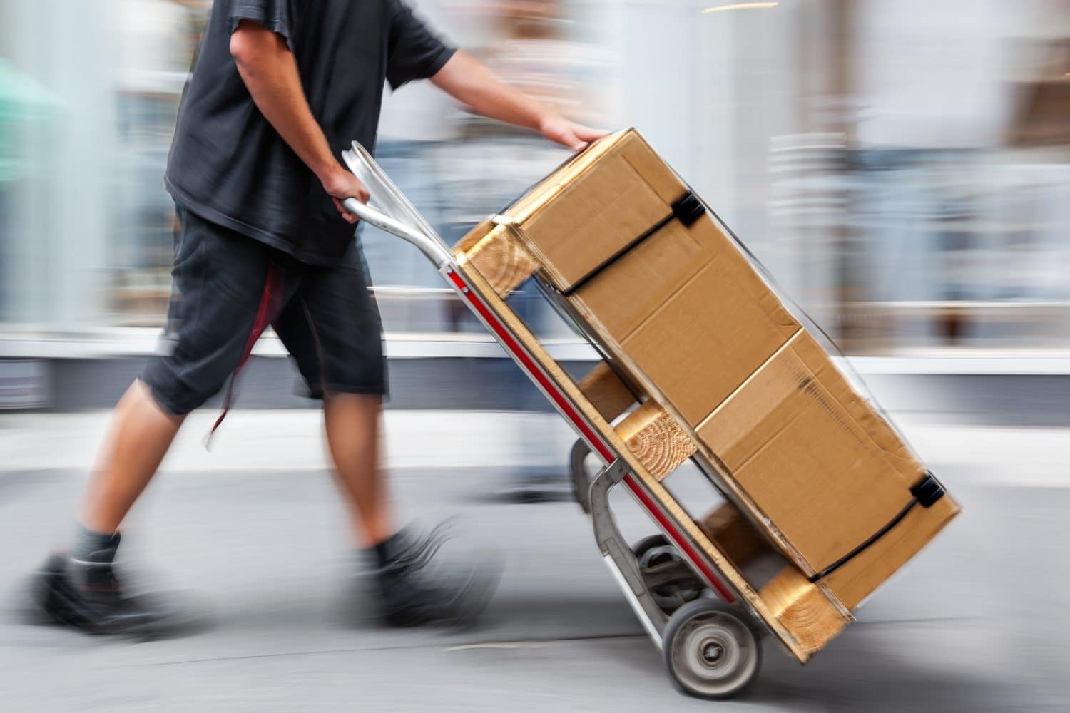 Delivery goods with dolly by hand, purposely motion blur